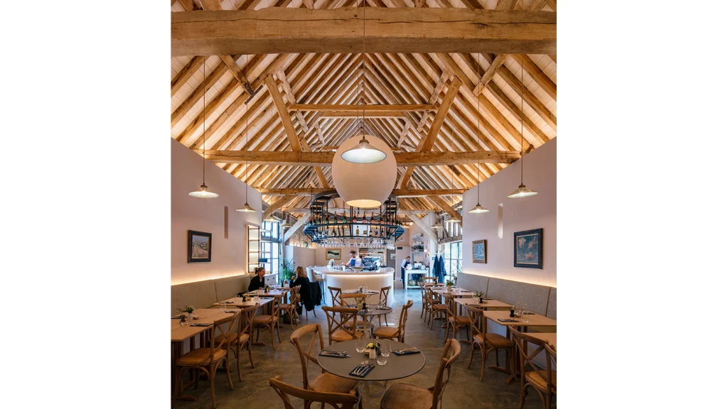 Wiston Estate has completed a £6m refurbishment through ECE Architecture to create substantial wine storage and tasting facilities plus dining spaces, repurposing farm buildings in a way that celebrates the regional materials and typologies. Image Credit: Will Scott Photography